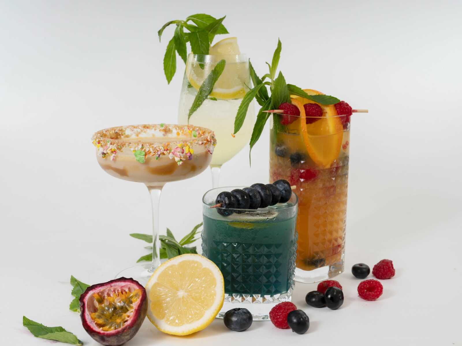 A vibrant display of refreshing fruit juices with fresh ingredients around.
